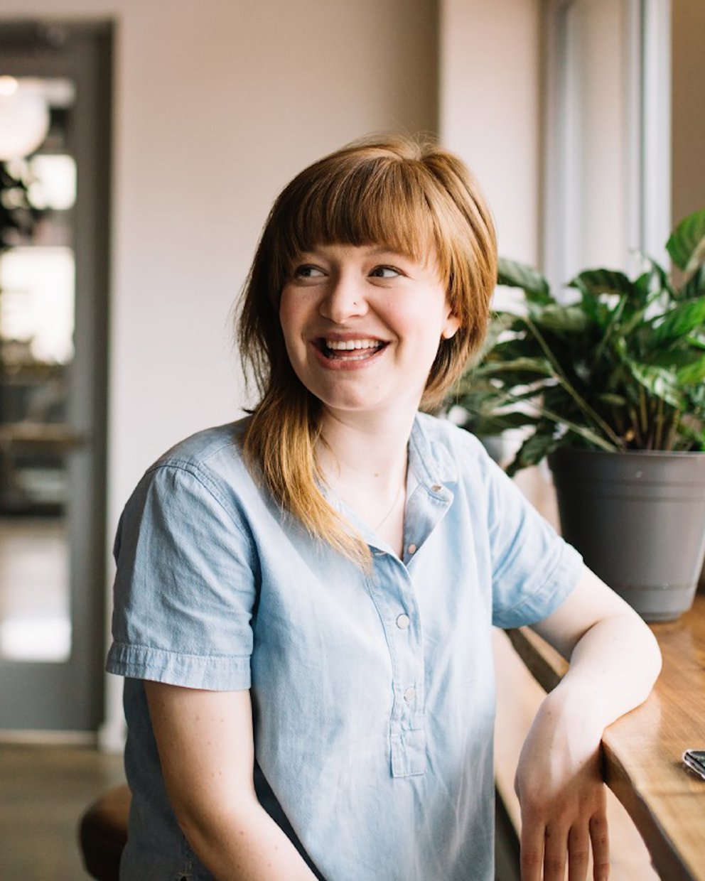 Smiling woman in front of a window