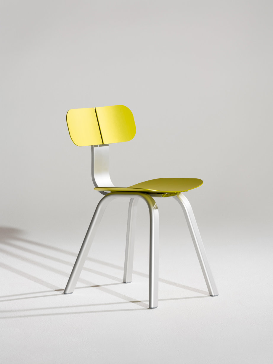 a yellow chair with a green cushion