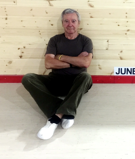 a man sitting on a ramp with his arms crossed