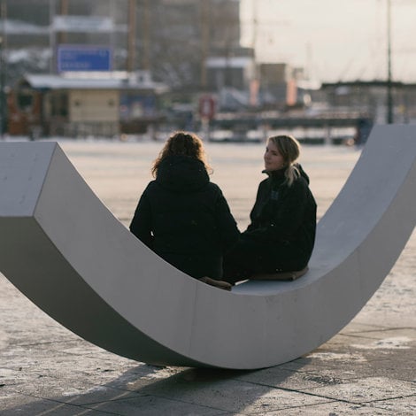 two people sitting on a large white sign