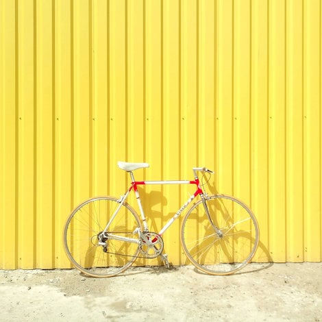 a bicycle leaning against a wall