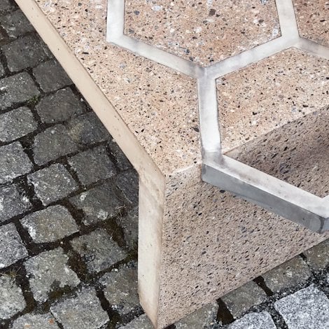 Concrete bench reinforced with exposed aluminium shapes