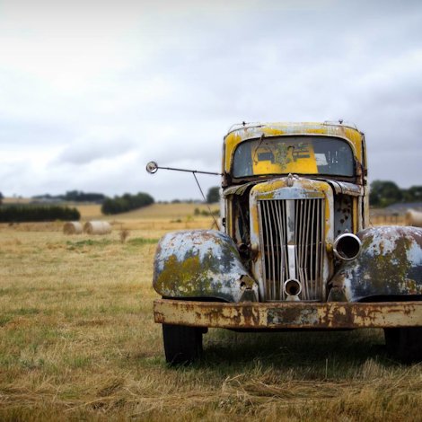 old rusted car in a field