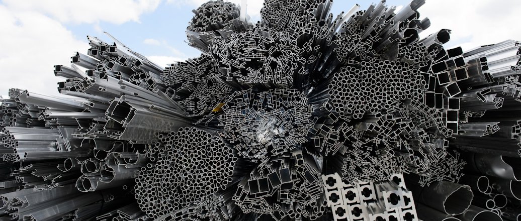 heap of aluminium rods and extruded profiles