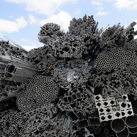 heap of aluminium rods and extruded profiles