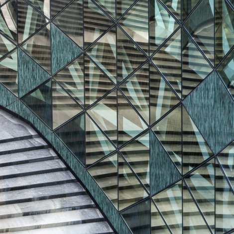 building facade with diamond shaped glass and stone panels